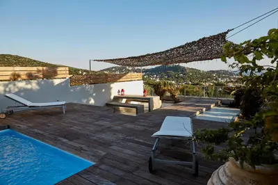 a patio with a pool and a table and chairs at Magnificent, Deluxe Villa, Lagonisi, Athens Riviera in Áyios Nikólaos