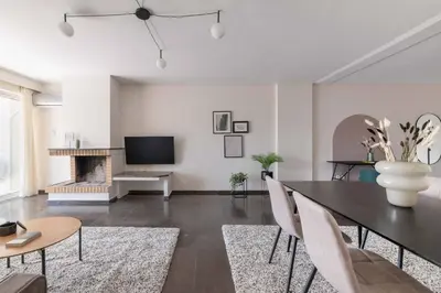 a living room with a dining table and a fireplace at Serene 2BR Apartment in Alimos with Sea view by UPSTREET in Athens