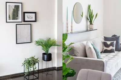 a living room with a white couch and plants at Serene 2BR Apartment in Alimos with Sea view by UPSTREET in Athens
