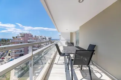 a balcony with a table and chairs on a building at Serene 2BR Apartment in Alimos with Sea view by UPSTREET in Athens