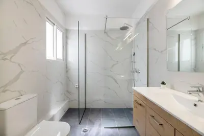 a bathroom with a toilet and a sink and a shower at Serene 2BR Apartment in Alimos with Sea view by UPSTREET in Athens