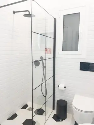 a glass shower in a bathroom with a toilet at NobleNotes - Victor Suite Central Athens in Athens