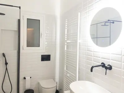 a white bathroom with a sink and a toilet at NobleNotes - Victor Suite Central Athens in Athens