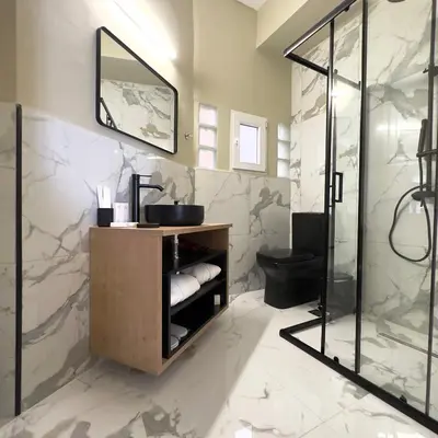 a bathroom with a shower and a sink and a mirror at Potnia Athens in Athens