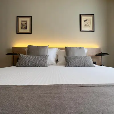 a large white bed with two pillows on it at Potnia Athens in Athens