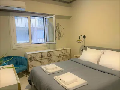 a bedroom with a bed with two towels on it at Apartment 55 Fix in Athens