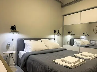a bedroom with a large bed with towels on it at Apartment 55 Fix in Athens