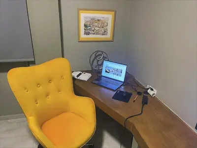 a desk with a laptop and a yellow chair at Apartment 55 Fix in Athens