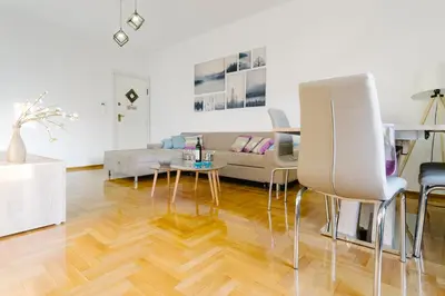 a living room with a couch and a table and chairs at Acropolis view apartment in Athens in Athens