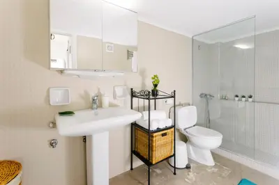 a white bathroom with a sink and a toilet at Acropolis view apartment in Athens in Athens
