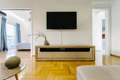 a living room with a flat screen tv on a wall at Acropolis view apartment in Athens in Athens