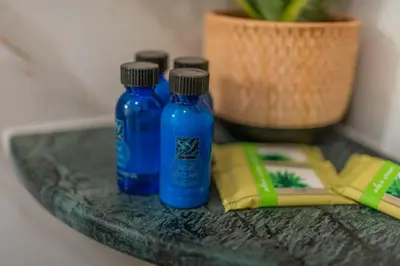 two blue bottles are sitting on a table at The Stone Manor , Noho boutique Thissio in Athens