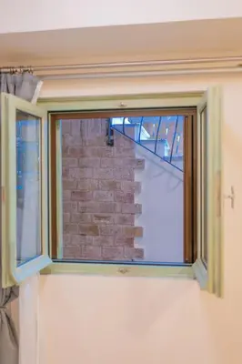 a window in a room with a brick wall at The Stone Manor , Noho boutique Thissio in Athens