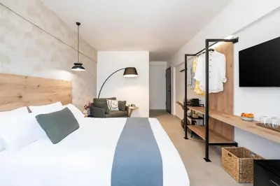 a hotel room with a bed and a tv at KOYO Athens in Athens