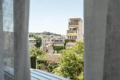 a view of a city from a window at KOYO Athens in Athens