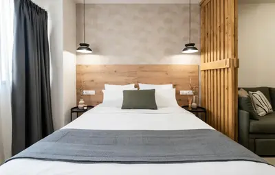 a bedroom with a large bed and a chair at KOYO Athens in Athens