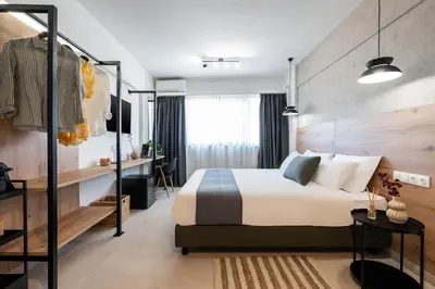 a hotel room with a bed and a desk at KOYO Athens in Athens