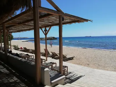 a beach with a bunch of chairs and the ocean at ALTHEA HOLIDAY STUDIO in Aghia Marina