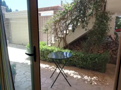 a glass table in front of a door at ALTHEA HOLIDAY STUDIO in Aghia Marina