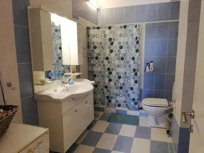 a bathroom with a toilet and a sink and a shower at ALTHEA HOLIDAY STUDIO in Aghia Marina