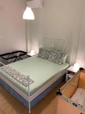 a bedroom with a bed with a metal bed frame at Lillian’s House in Athens