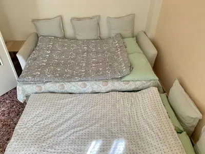 a bed with two pillows on it in a room at Lillian’s House in Athens