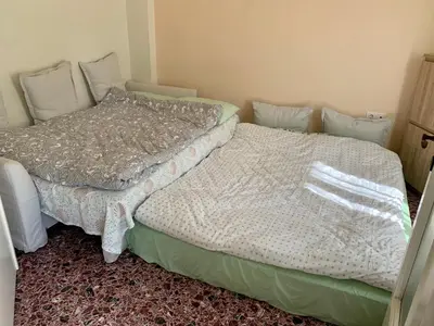 two twin beds in a room with at Lillian’s House in Athens