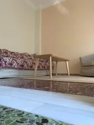 a wooden bench sitting next to a bed in a room at Lillian’s House in Athens