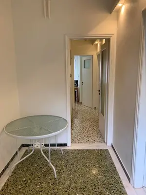 a glass table in a room with a hallway at Lillian’s House in Athens