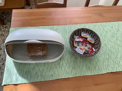 a toaster and a basket of candy on a table at Lillian’s House in Athens