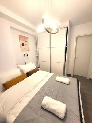 a bedroom with a large bed with two towels on it at THE NEW Diamont of Athens in Athens