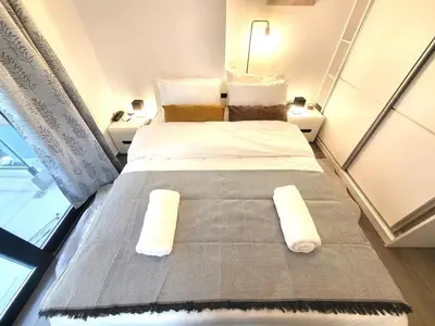 a bedroom with a bed with two pillows on it at THE NEW Diamont of Athens in Athens