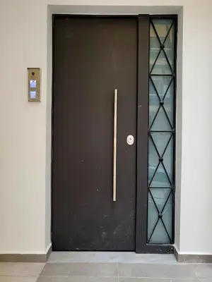 a black door with a wooden handle on it at THE NEW Diamont of Athens in Athens