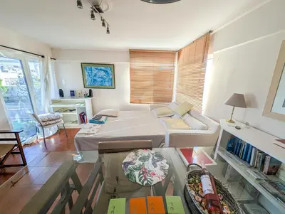 a bedroom with a bed and a table with books at Sacred Way rooftop apartment in Athens