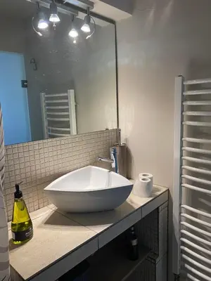 a bathroom with a large white sink and a mirror at Sacred Way rooftop apartment in Athens