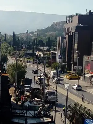 a view of a city street with cars and traffic at Sacred Way rooftop apartment in Athens