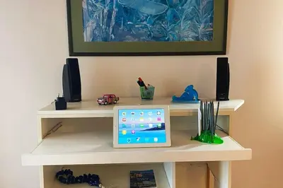 a desk with a computer on it with speakers at Sacred Way rooftop apartment in Athens
