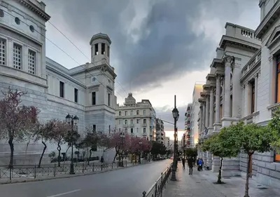 a city street with buildings and a clock tower at NobleNotes - Isabella Suite Central Athens in Athens