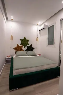 a bedroom with a large bed with stars on it at NobleNotes - Isabella Suite Central Athens in Athens