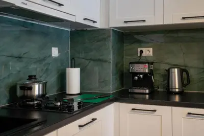 a kitchen with white cabinets and a stove top oven at NobleNotes - Isabella Suite Central Athens in Athens