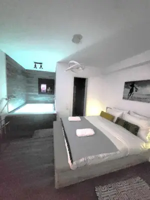 a bedroom with a large bed in a room at Romantic Suite&GRANT Jacuzzi in Athens