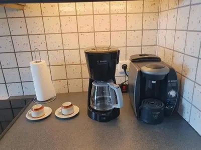 a coffeemaker sitting on a counter next to a coffee maker at Sea Satin Anavyssos in Anavissos