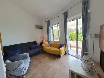 a living room with a couch and a bed at Sea Satin Anavyssos in Anavissos