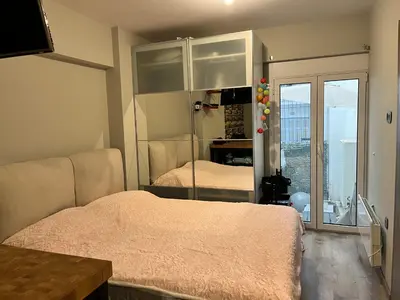a bedroom with two beds and a large window at Urban escape in Athens in Athens
