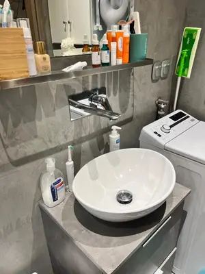 a bathroom with a white sink on a counter at Urban escape in Athens in Athens