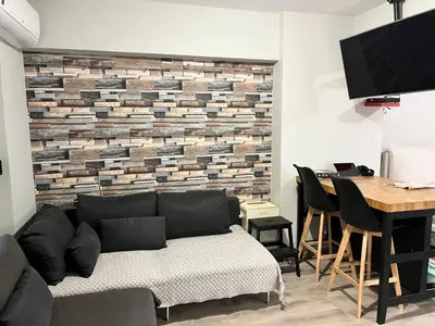 a living room with a couch and a table at Urban escape in Athens in Athens