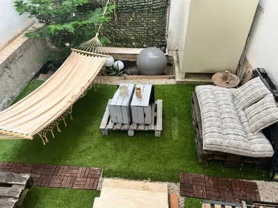 a hammock and a couch and a table and a hammock at Urban escape in Athens in Athens