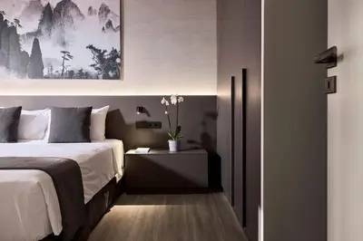 a bedroom with a bed and a table with a plant at Athens Metropolitan Grand Residence in Athens