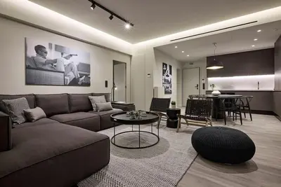 a living room with a couch and a table at Athens Metropolitan Grand Residence in Athens