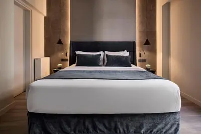 a bedroom with a large bed with two pillows at Athens Metropolitan Grand Residence in Athens